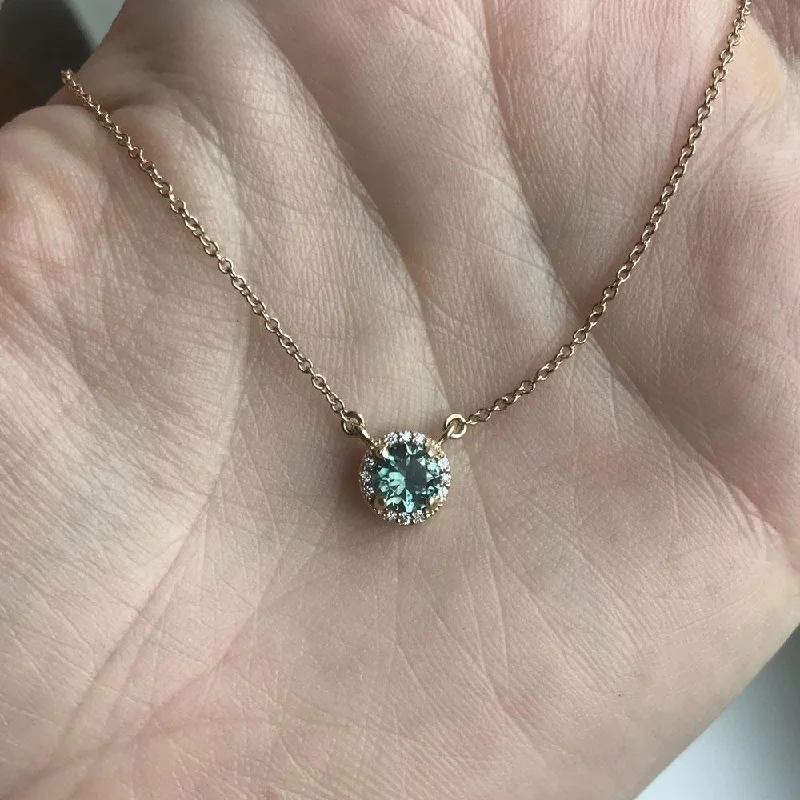 vintage-style floral brooch Madagascar Sapphire and diamond halo necklace in 14k gold vintage-style floral brooch Madagascar Sapphire and diamond halo necklace in 14k gold